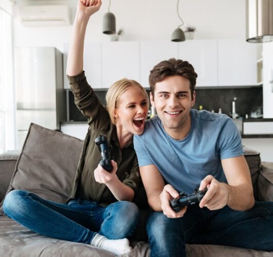 happy-couple-playing-video-games-looking-camera_171337-4104